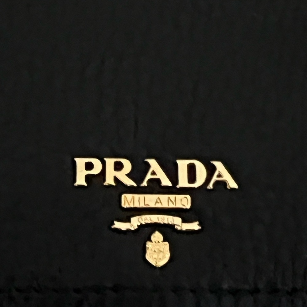 Authentic black leather wallet made in Italy with a beautiful gold emblem.